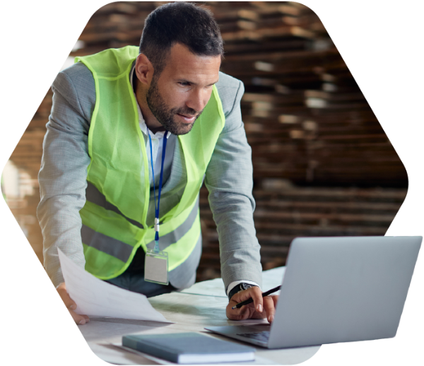 Construction worker on laptop.