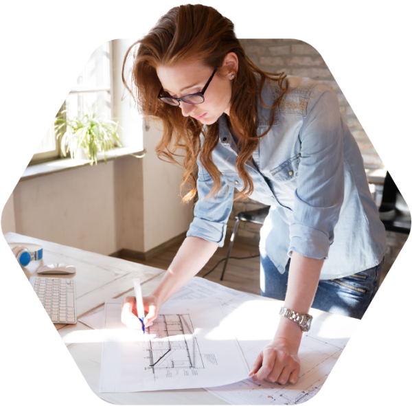 Woman working on construction blueprints