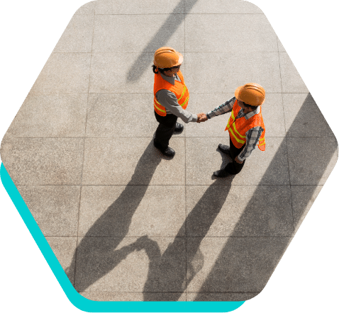 Construction worker shaking hands aerial view