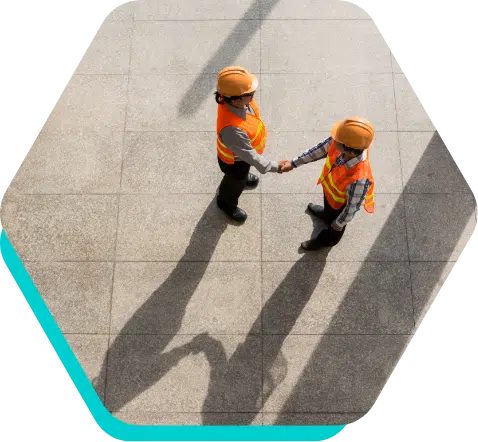 Construction worker shaking hands aerial view